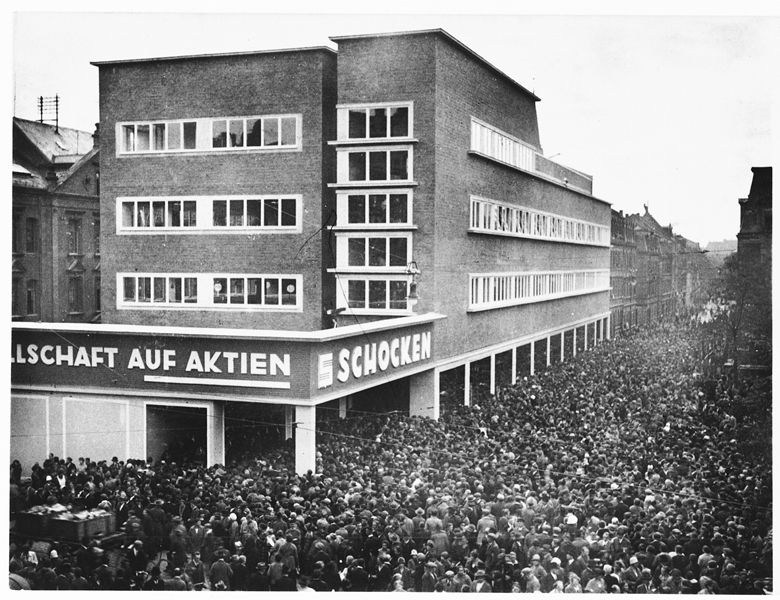 A crowd of people gather outside the Schocken department store in Nuremberg